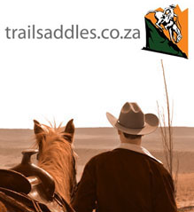 The trailsaddles logo above a cowboy looking into the distance with his saddled horse. The cowboy wears a Stetson Hat
